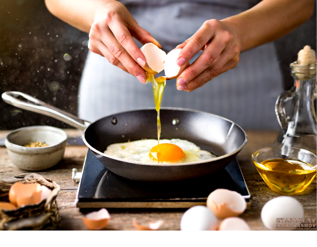 cracking eggs in pan
