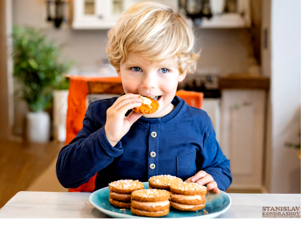 little boy eating carrot cake sandwich cookies